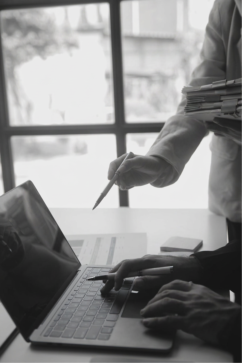 Two people reviewing work on a laptop