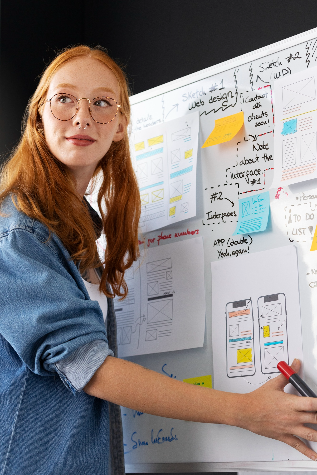 Designer in front of a board of sketches